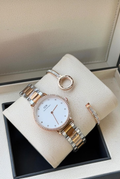 Two-tone white dial watch and two slim bracelets displayed in box