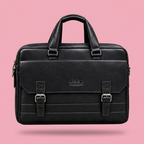 Black double-buckle briefcase bag on a soft pink background, square image