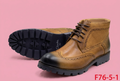 Tan brogue ankle boots on soft pink background