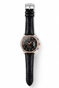 Black-dial watch with rose-gold-tone case and black embossed strap on white background