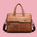 Brown briefcase shoulder bag on a soft pink background