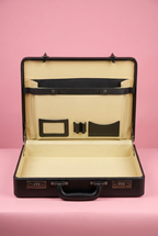 Open black briefcase with cream interior organiser and two combination locks