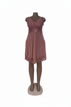 Pink lace babydoll dress on white background